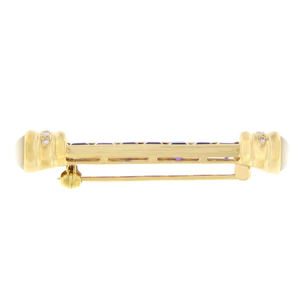 Side angle of elegant 18K yellow gold brooch displaying amethyst center stones surrounded by diamonds and moonstones in luxury jewelry