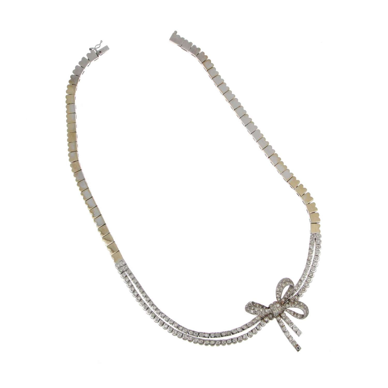 Close-up angle showing sparkling round brilliant diamonds set in 18kt white gold on a luxurious pearl necklace
