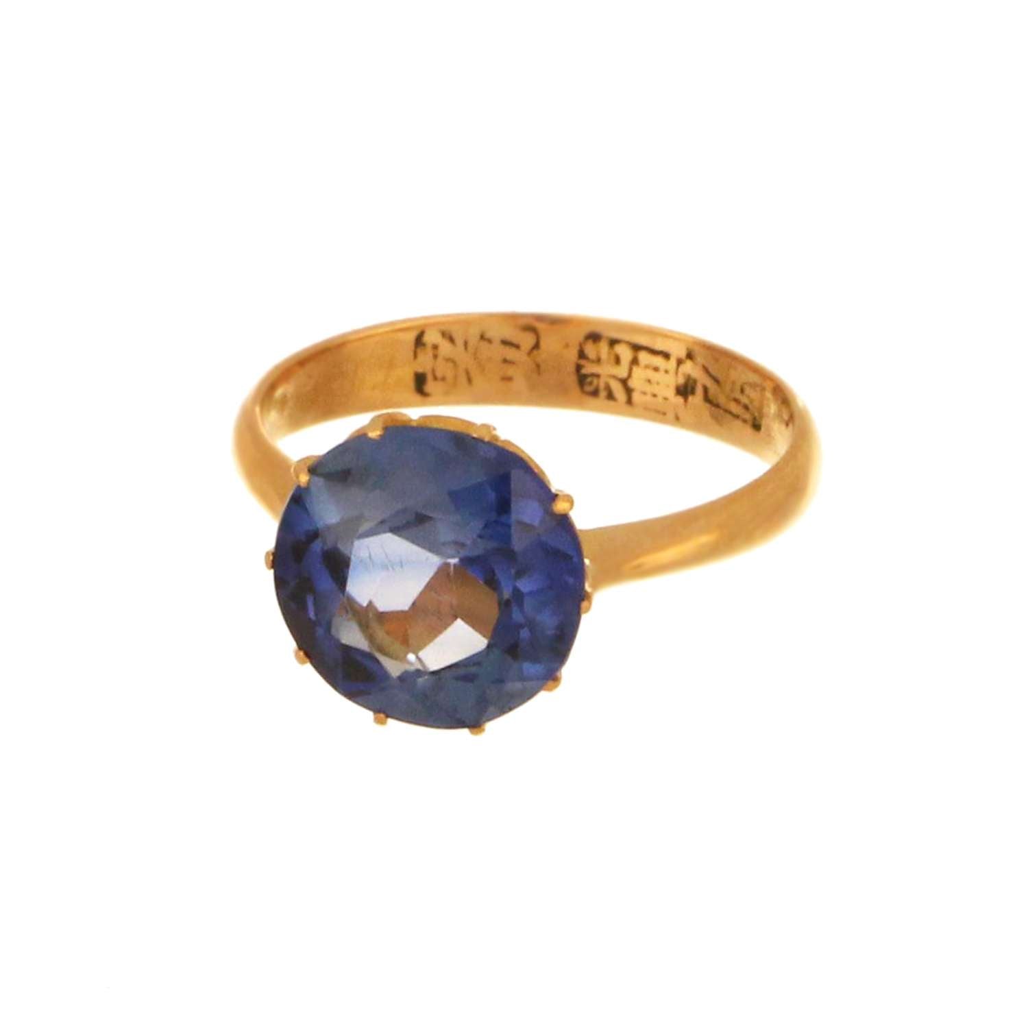 Full view of 21kt yellow gold synthetic blue sapphire ring with round stone, ring size 4