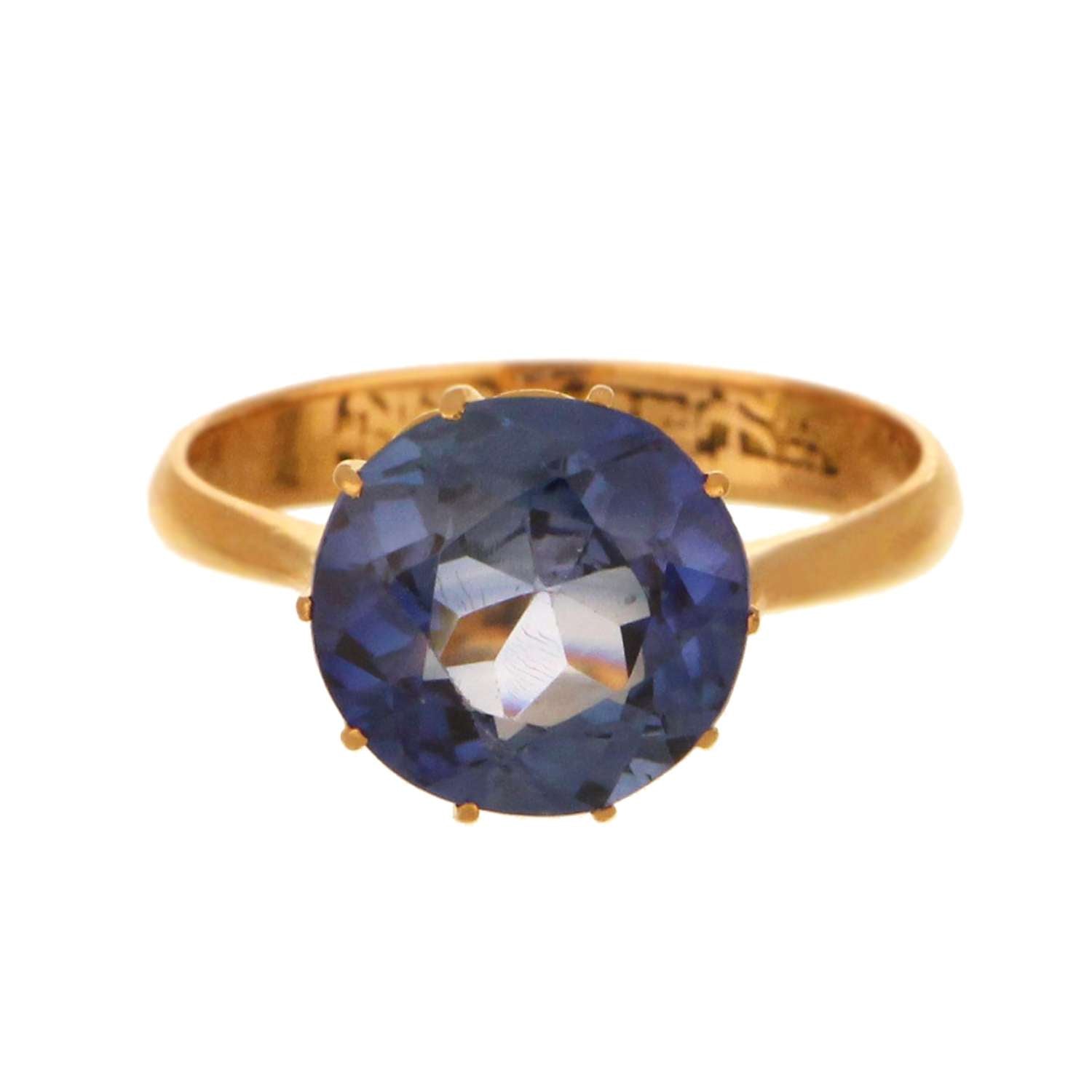 21kt yellow gold ring featuring a round synthetic blue sapphire approximately 9mm viewed from angled top
