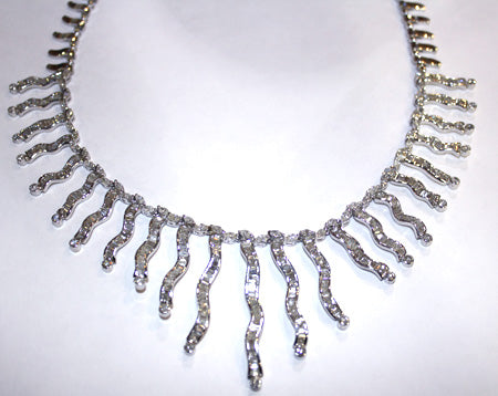 Side angle view of luxurious 18kt white gold diamond necklace showcasing intricate diamond arrangement