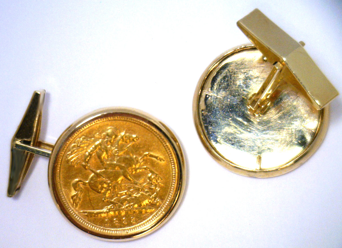 Pair of 14kt yellow gold plain style cufflinks with half sovereign coin mounts, angled view showing polished finish and clasp mechanism