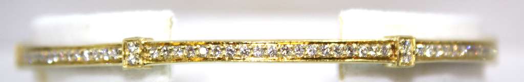 Close-up of 18kt yellow gold bangle featuring 138 round brilliant cut diamonds set in a continuous row, showcasing sparkle and luxury