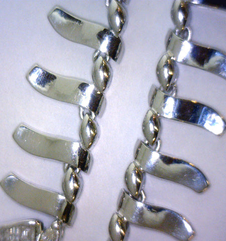 Artistic close-up showcasing diamond clarity and color on white gold setting of necklace