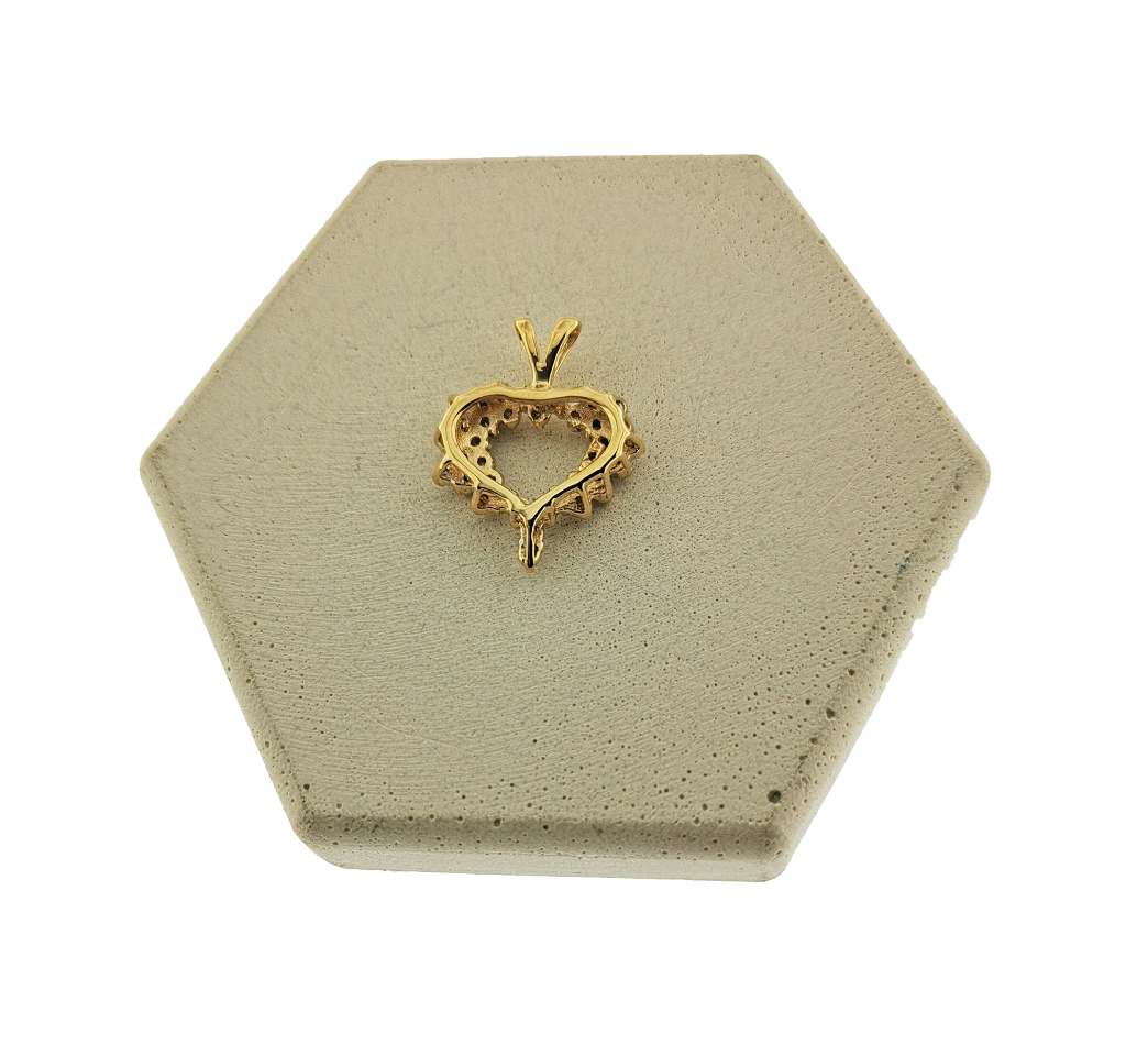Side angle view of 14kt yellow gold heart style diamond pendant showcasing diamond arrangement and lustrous finish