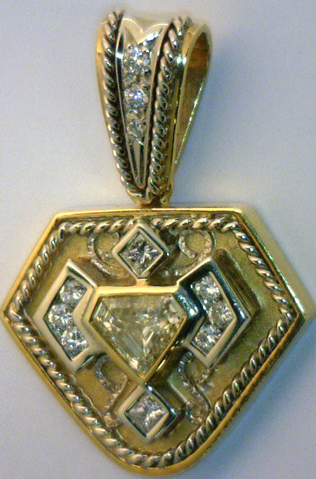 Close-up of 18kt yellow and white gold diamond pendant featuring 1.18ct center diamond with full bezel setting and multiple smaller round and princess cut diamonds, polished and brushed finish