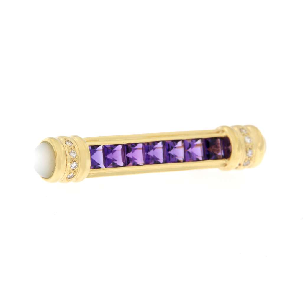 Detailed shot of vintage 18K yellow gold amethyst diamond and moonstone brooch, showing stone arrangement and gold finish