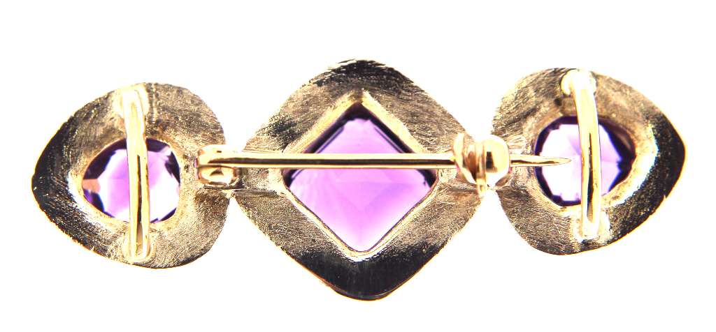 Side view of elegant 14kt white and yellow gold amethyst brooch revealing full bezel setting