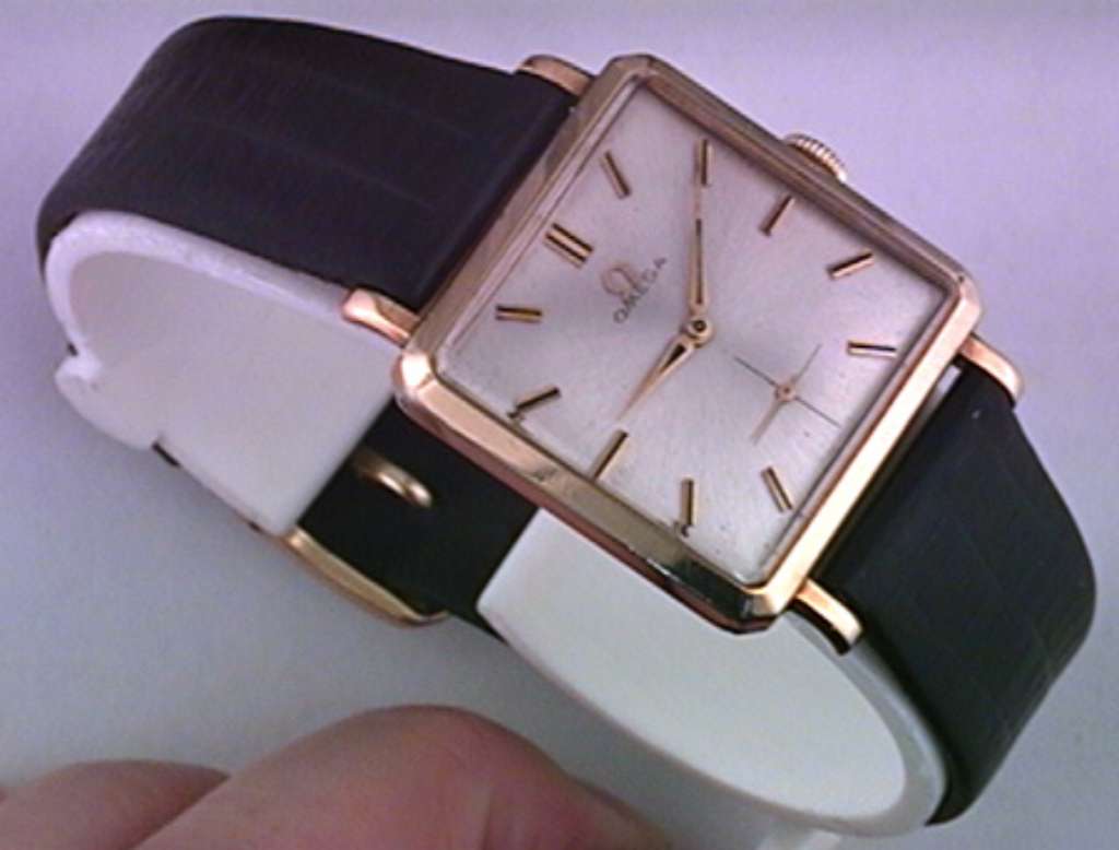 Men's Omega watch showing yellow 10KT gold filled case and black leather strap, front angle
