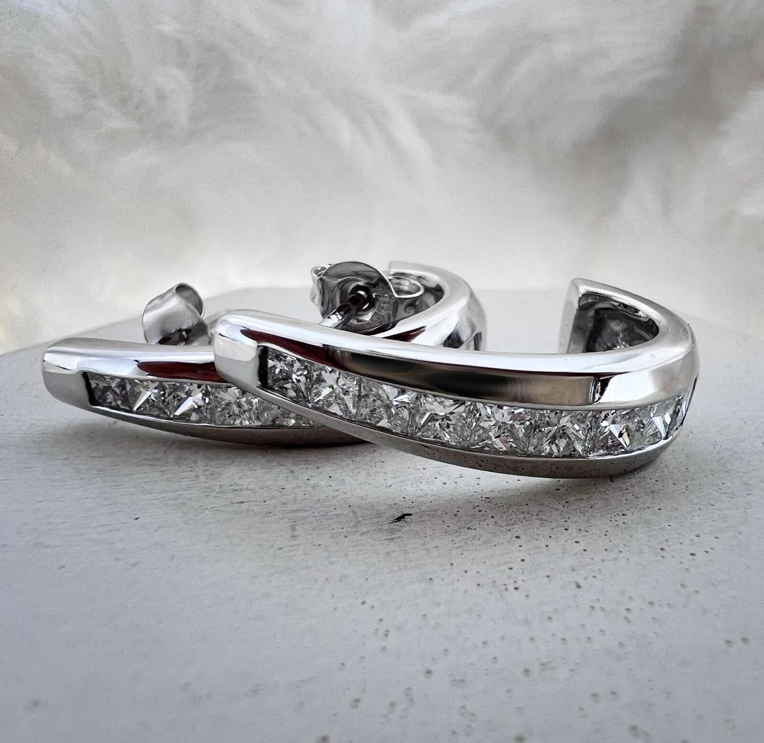 18kt white gold earring showcasing 18 princess cut diamonds totaling 1.68 cttw, elegant front view