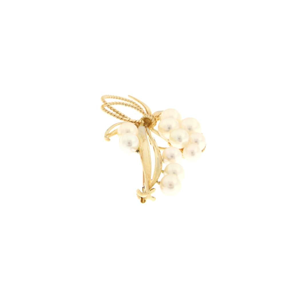 Side view of 14kt yellow gold pearl brooch showcasing pearl settings and solid gold weight