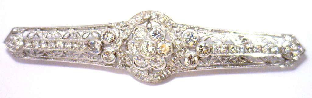 14kt white gold diamond brooch showcasing round brilliant cut diamonds in a vintage floral motif, front angle