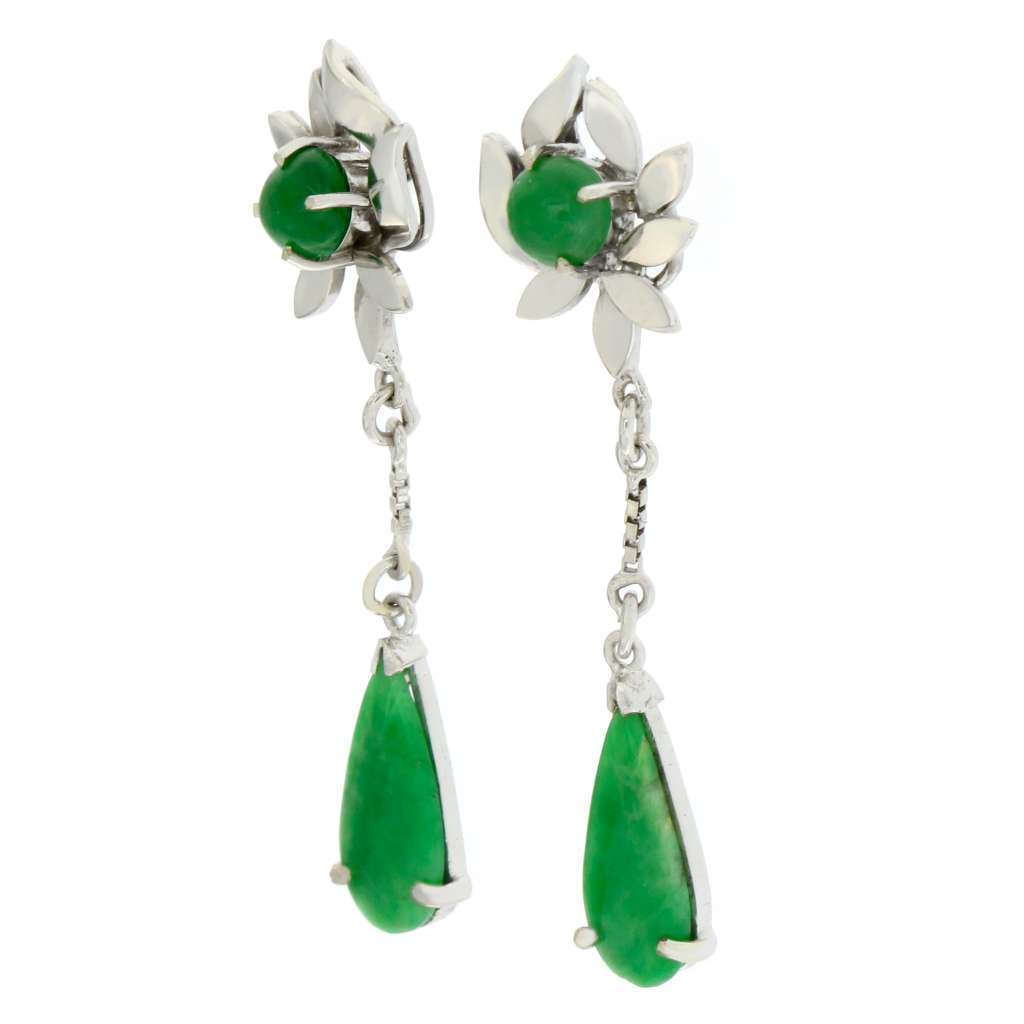 Close-up of 14kt white gold jade earring displaying pear-shaped jade stone set, showing luminous green color