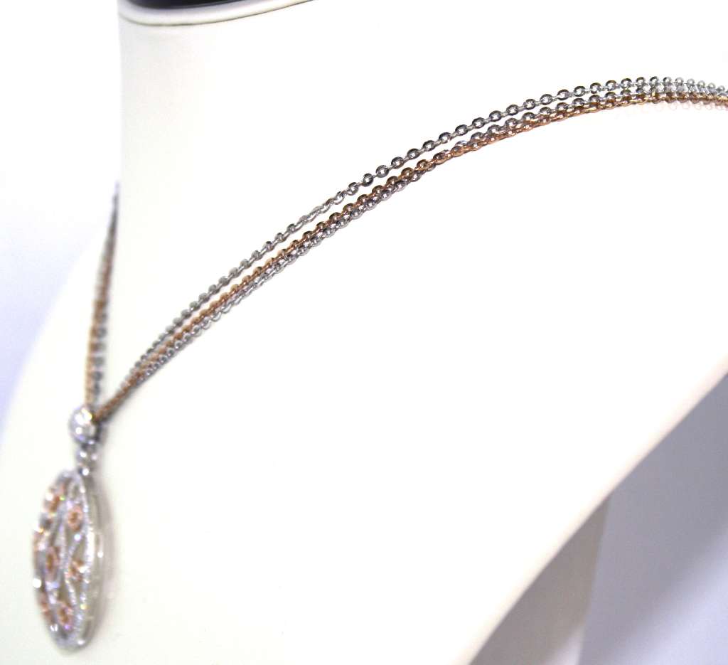 Close-up of 18kt white and rose gold pendant featuring 393 round brilliant diamonds totaling 1.91cttw