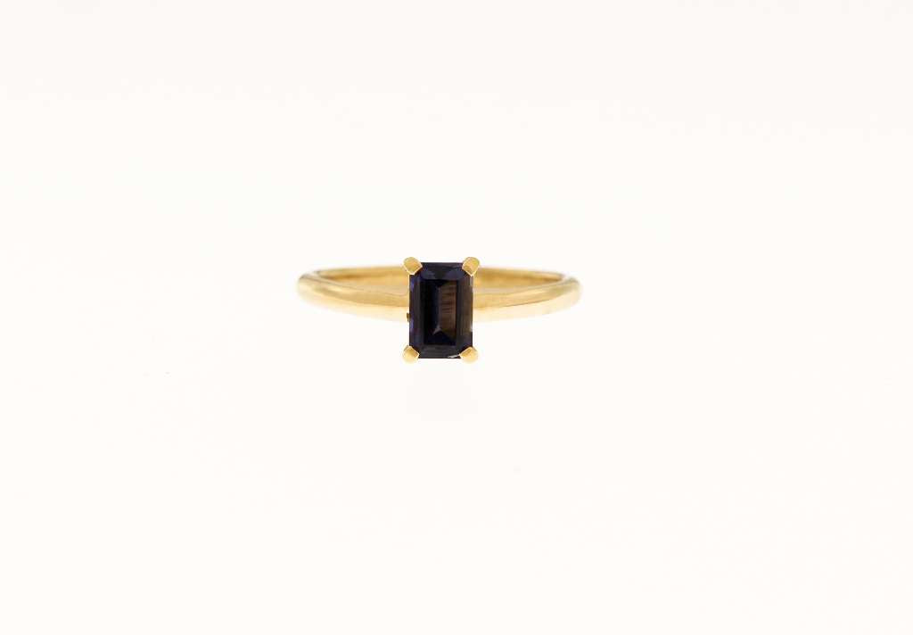 Side profile of elegant ladies' 18kt yellow gold ring featuring prominent emerald-shaped Iolite stone