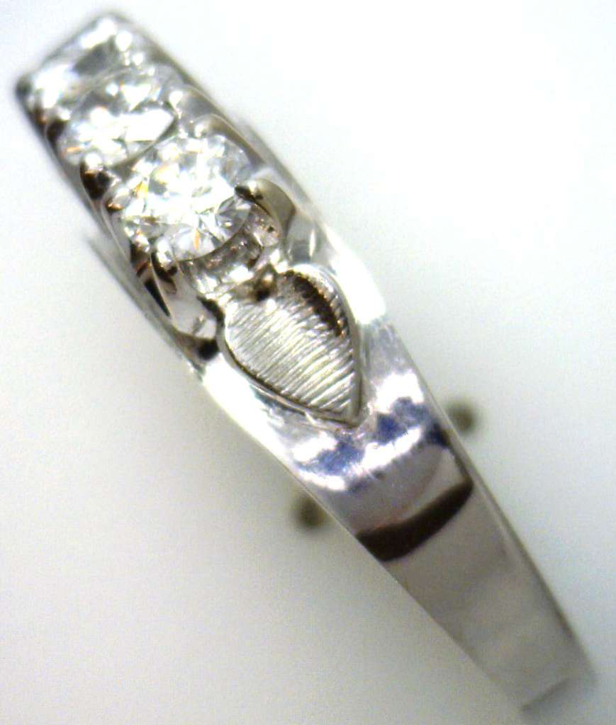 Elegant white gold diamond ring displayed on black fabric emphasizing brilliance and craftsmanship
