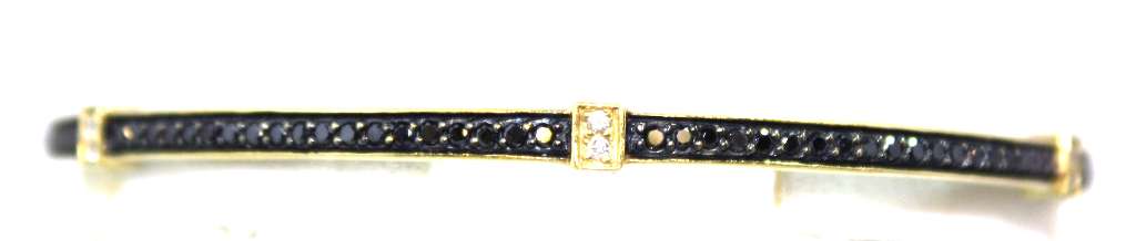 18kt yellow gold bangle with 114 round black diamonds and 24 white diamonds close-up view showing polished finish and diamond sparkle