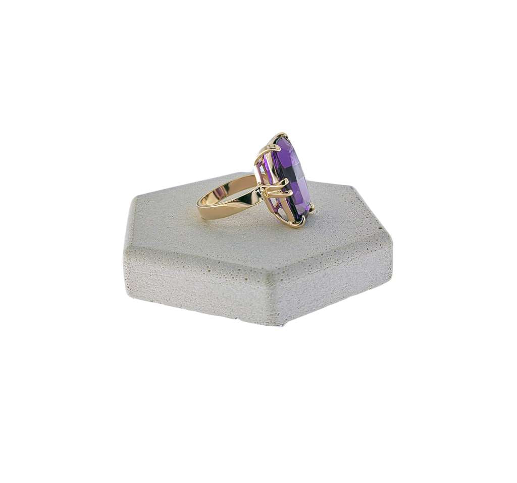 Side profile of 14kt yellow gold amethyst ring showcasing claw setting and band detail