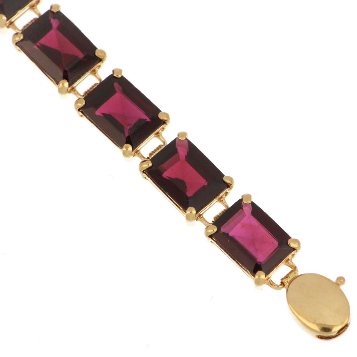 Side angle of elegant 14kt yellow gold garnet bracelet showcasing 17 baguette-shaped garnets in secure claw settings