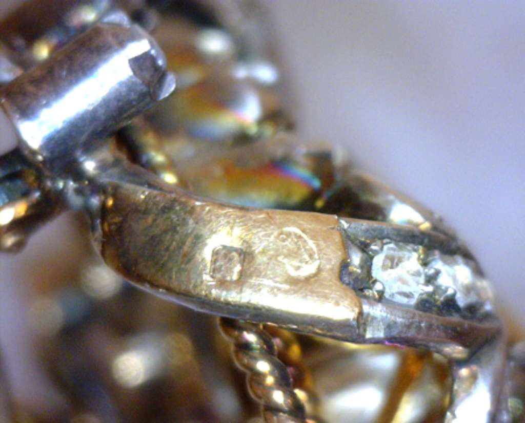 Close-up of Victorian brooch showcasing bezel-set square white opal and delicate rose-cut diamond bead setting in 18kt gold