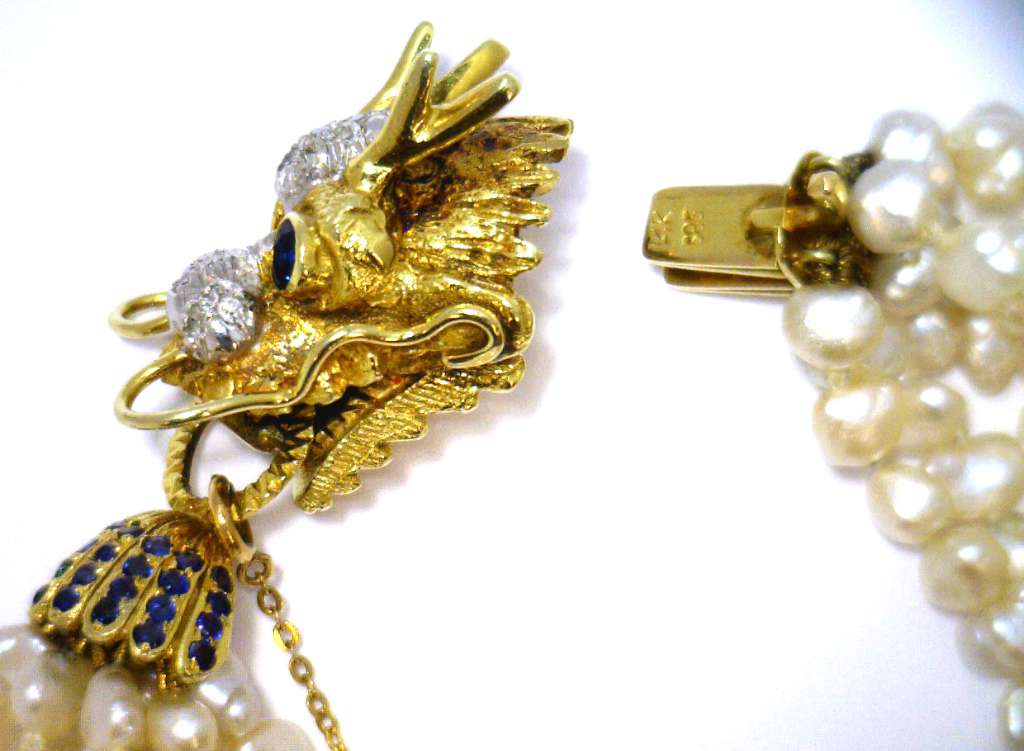 Side angle showing lustrous freshwater pearls combined with elegant 14kt yellow gold dragon clasp