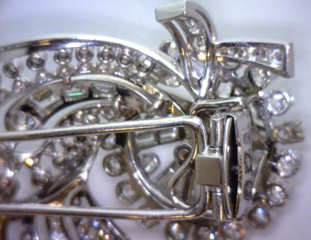 Flower-motif platinum and white gold diamond brooch with round brilliant and baguette diamonds