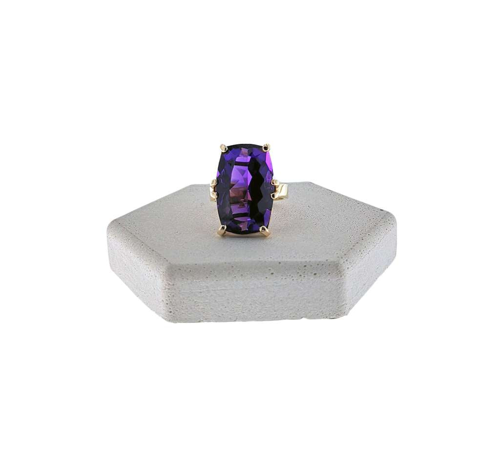 14kt yellow gold ring featuring a large oval purple amethyst gemstone viewed from above