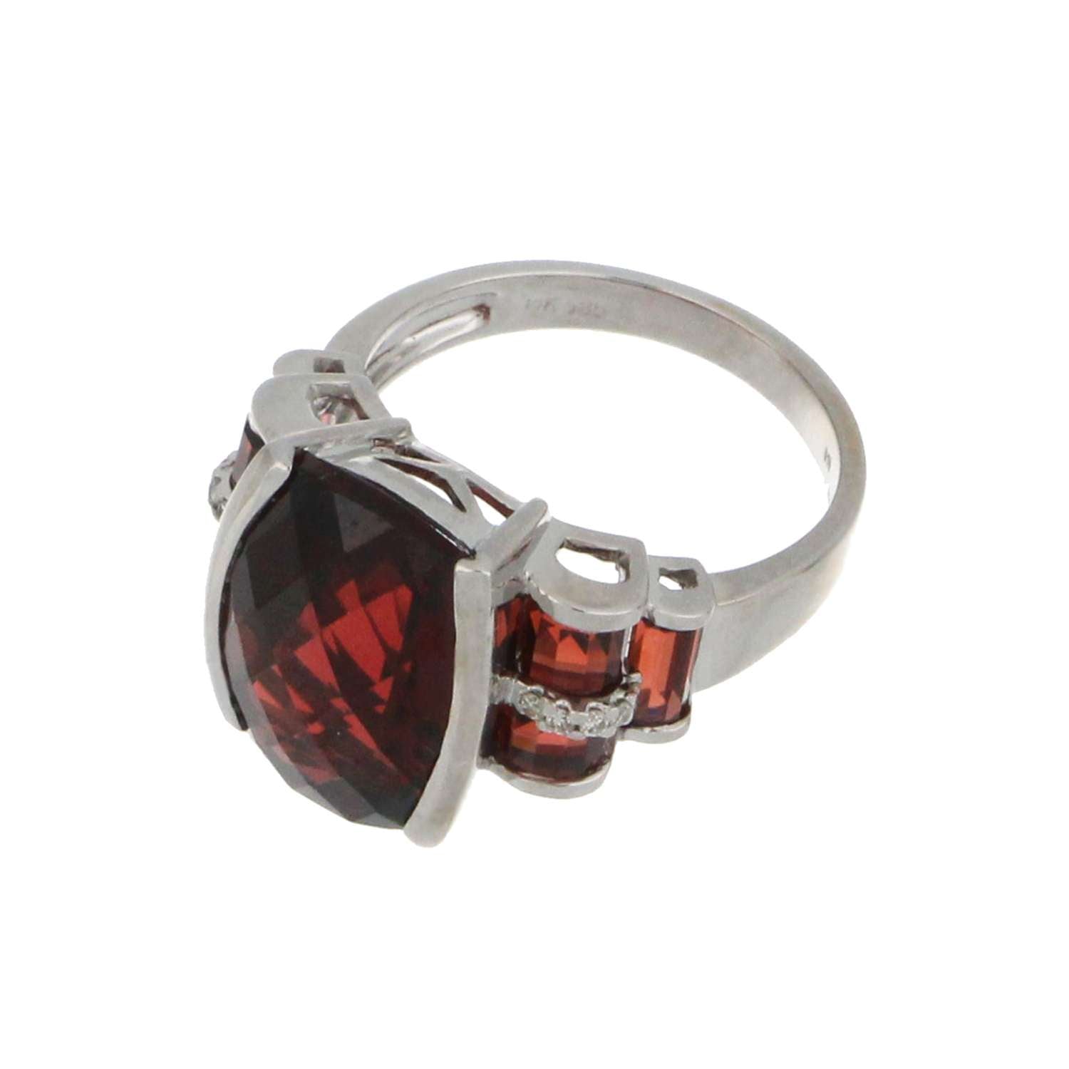 Side angle view of 14kt white gold garnet ring highlighting polished finish and gemstone arrangement