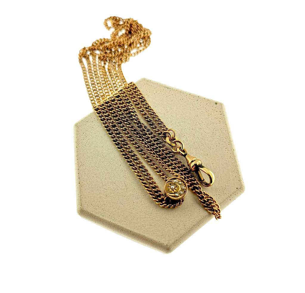 Detailed view of the sliding pearl charm on 10kt yellow gold pocket watch chain, showing craftsmanship and pearl arrangement