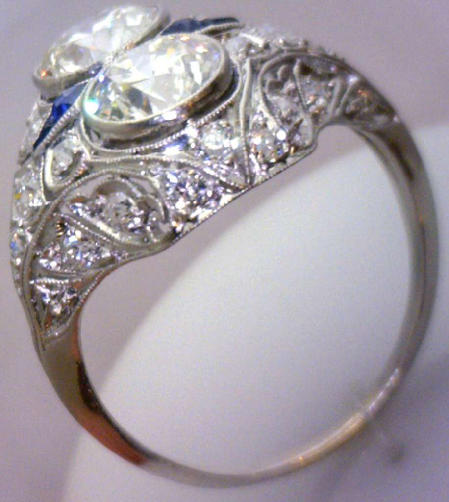 Side profile of the platinum diamond and blue sapphire ring showing the arrangement of stones and polished platinum band