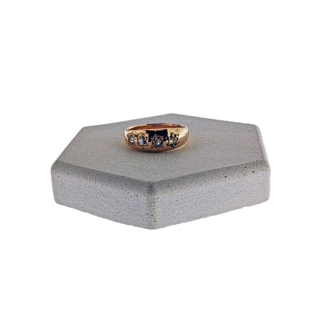 18kt yellow gold diamond band ring with four old mine cut diamonds, top angle displaying vintage diamond setting