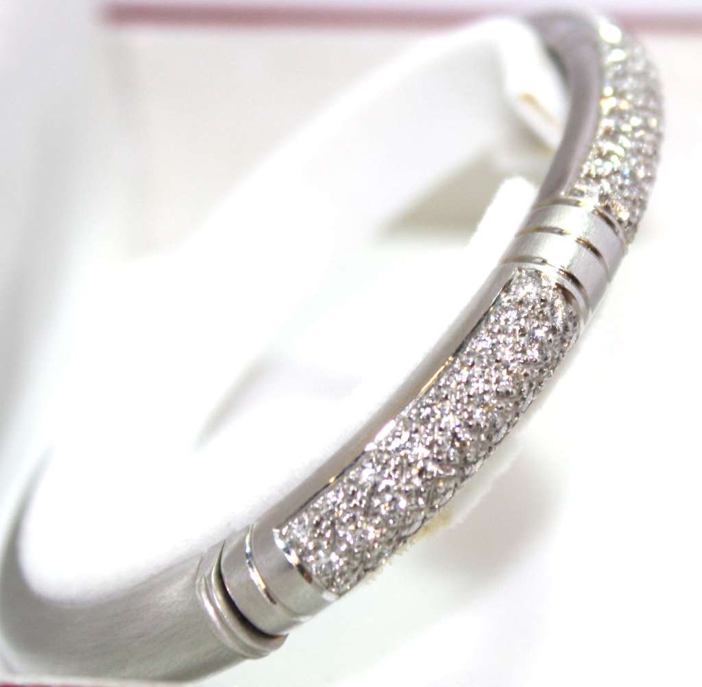 Elegant 18kt white gold diamond bangle viewed from side angle highlighting smooth curvature and diamond sparkle