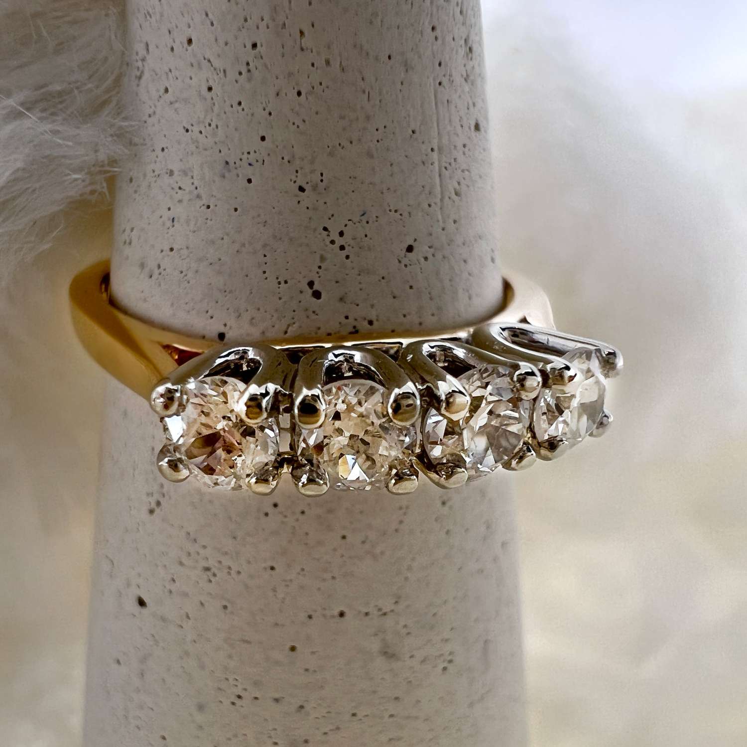 Close-up view of 14kt yellow gold diamond ring showcasing the clarity and arrangement of four old European cut diamonds