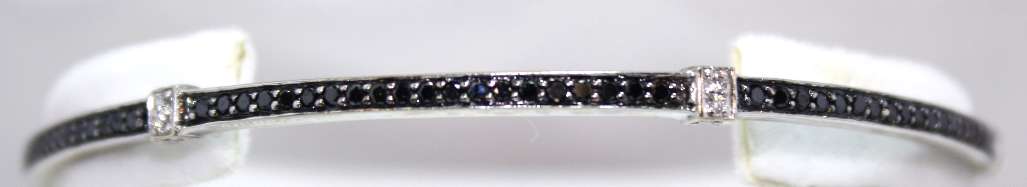 18kt white gold diamond bangle showing round brilliant cut white and black diamonds, front angle