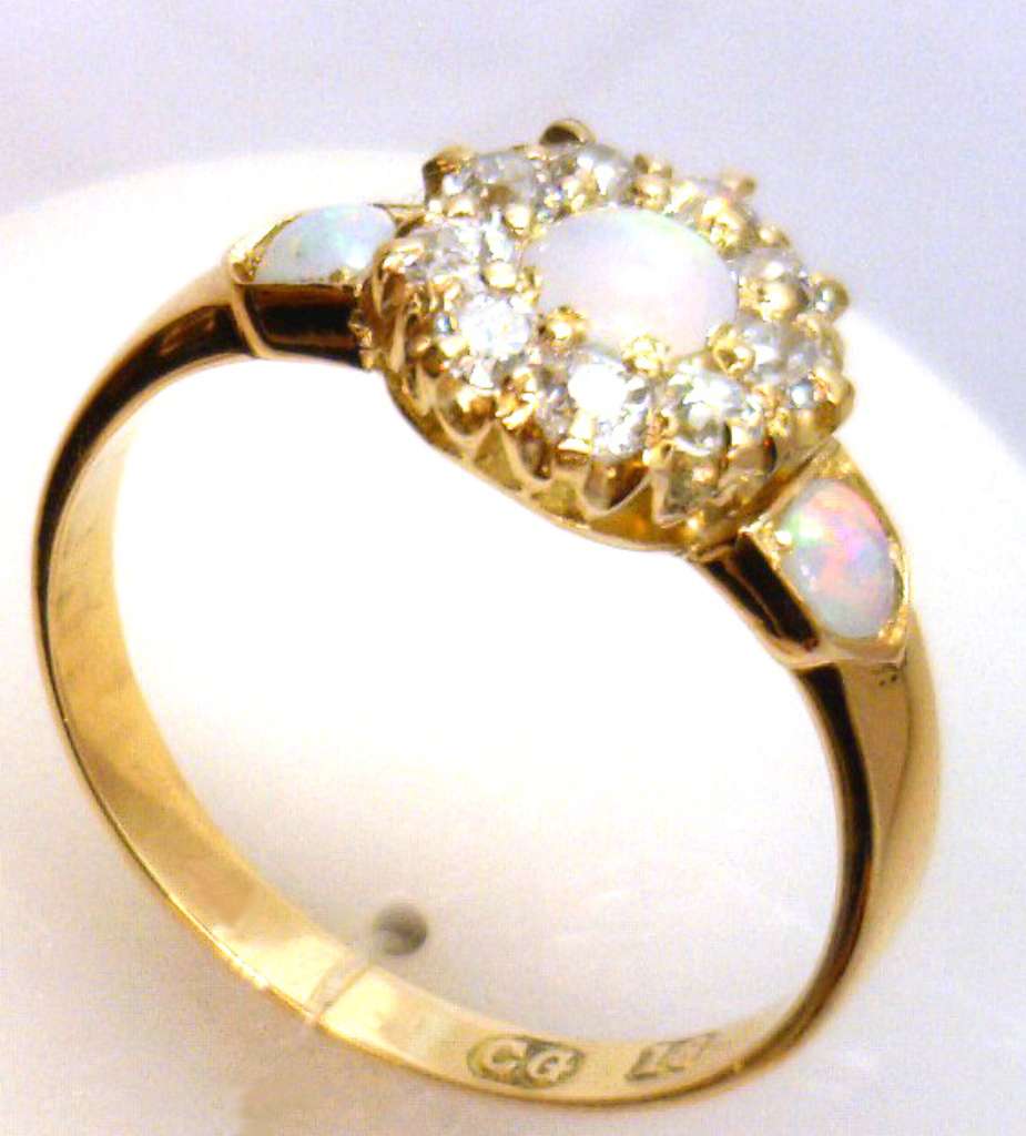 Top angle of 18kt yellow gold ring revealing arrangement of opals and sparkling old cut diamonds totaling 0.28 carats
