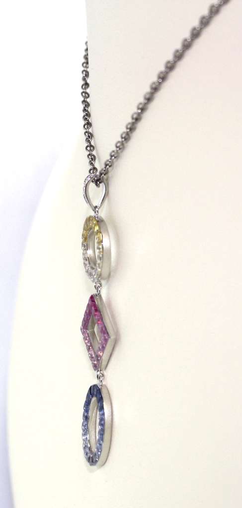 Side angle of elegant 18kt white gold pendant with mixed sapphire colors, showing depth and lustrous finish weighing 3.87 grams