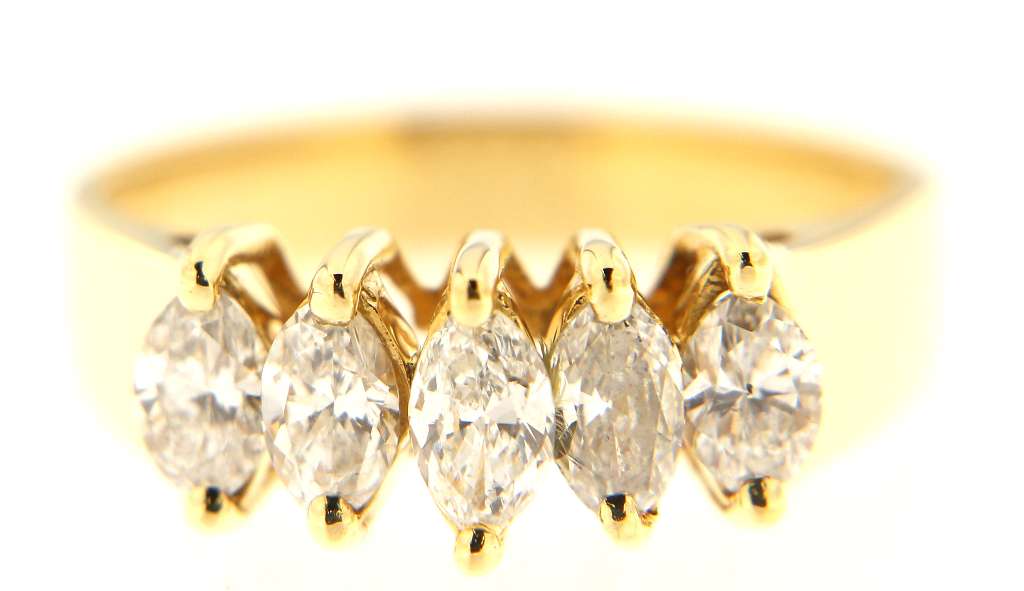 Side angle showcasing polished 14kt yellow gold band and marquise diamond arrangement on ring size 7