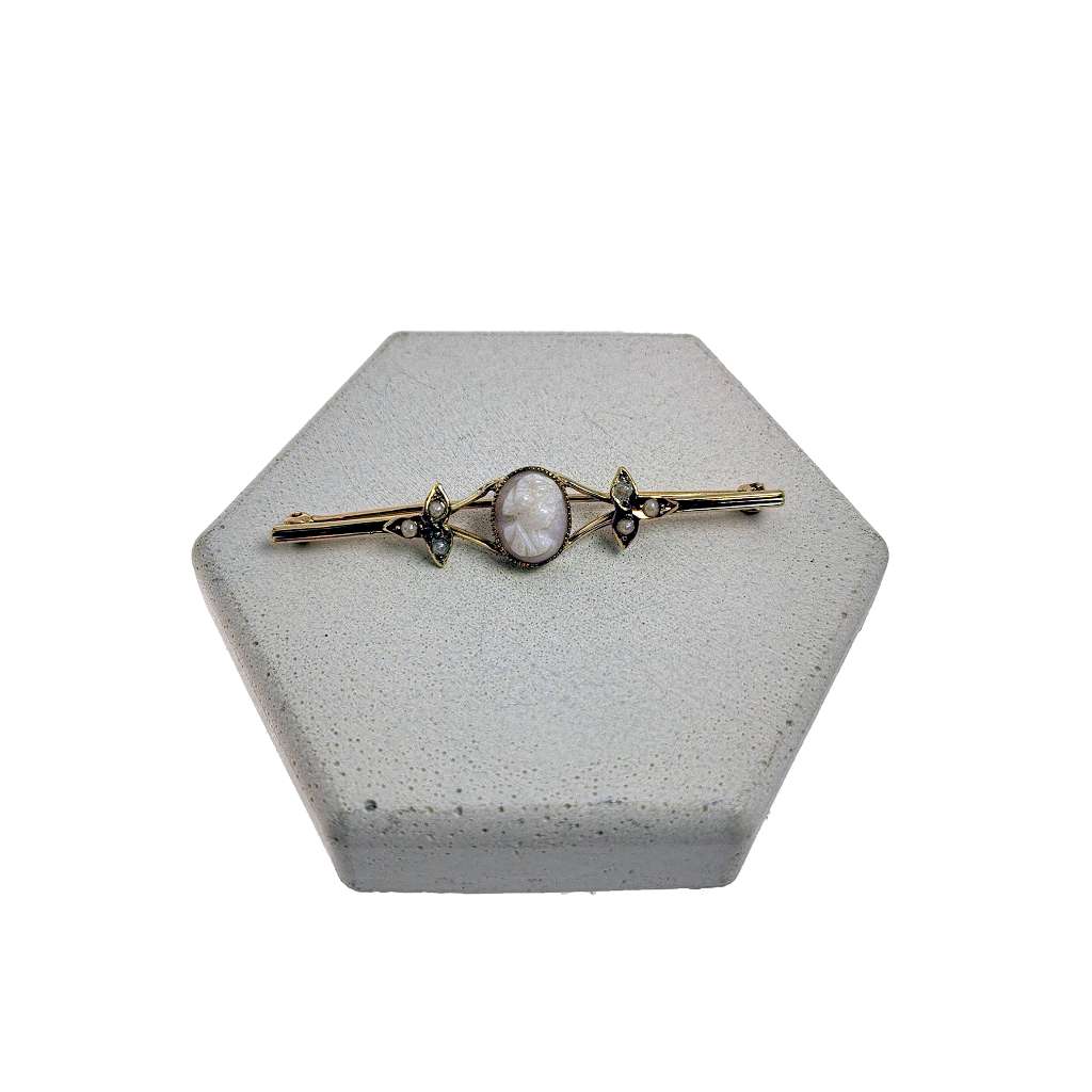 Antique 14kt yellow gold brooch featuring oval cameo and six seed pearls, top close-up view