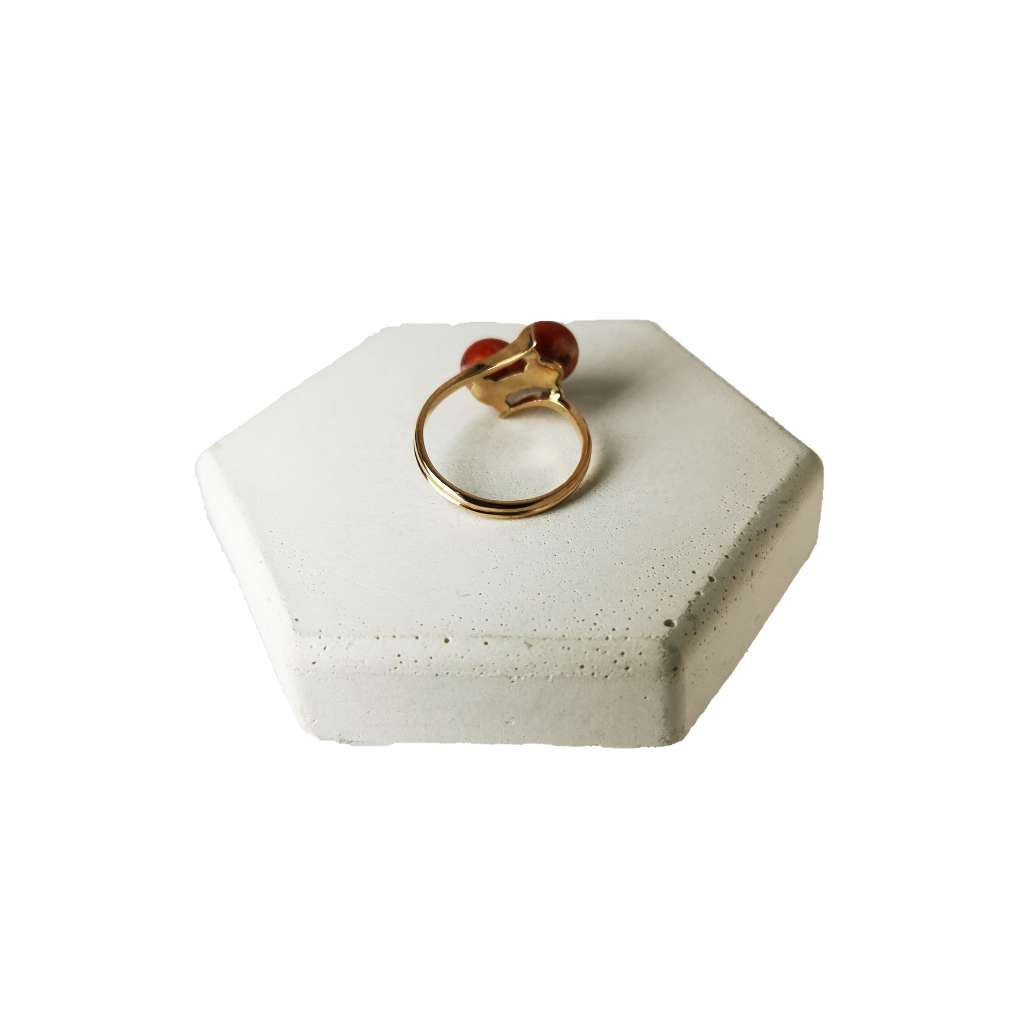 Detailed image of 10kt rose gold ring with red coral stones highlighting the rich color and polished finish