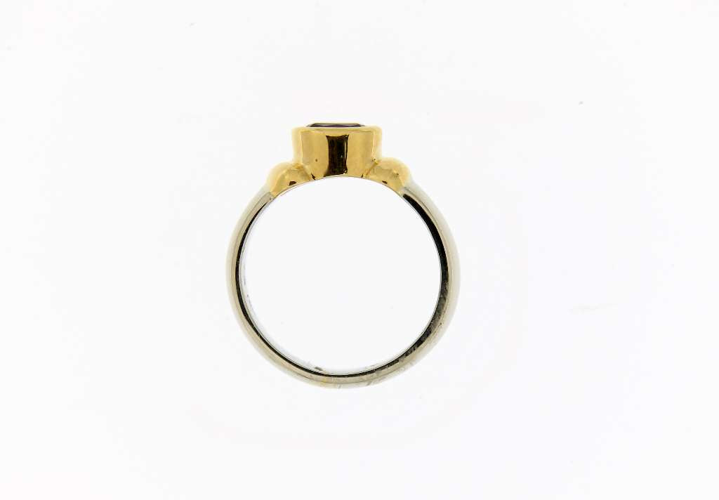 Top view of elegant 18K gold ring with oval purple tanzanite gemstone, weighing approximately 5.74 grams