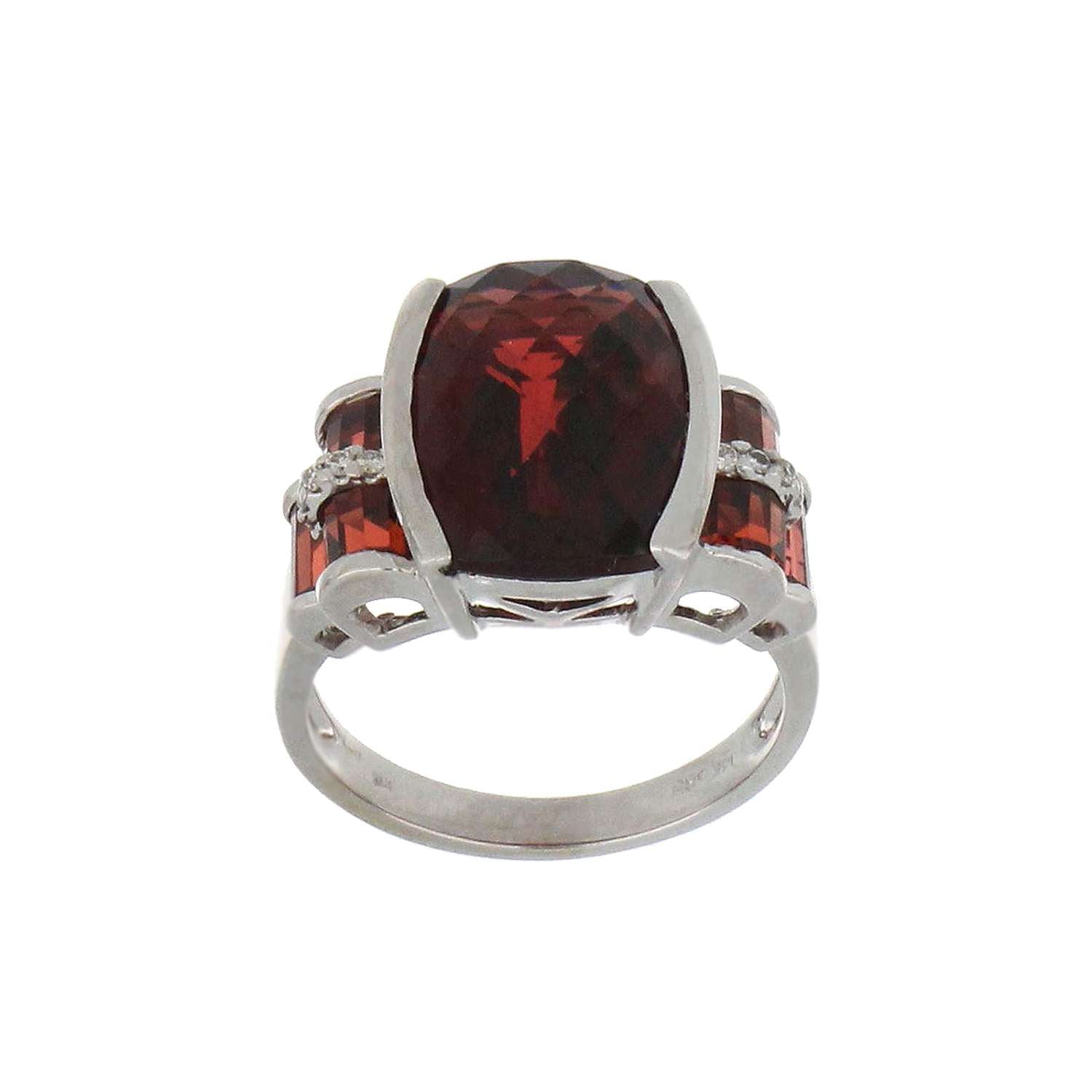 14kt white gold garnet ring showing central chess cut garnet and surrounding baguette garnets and diamonds detail