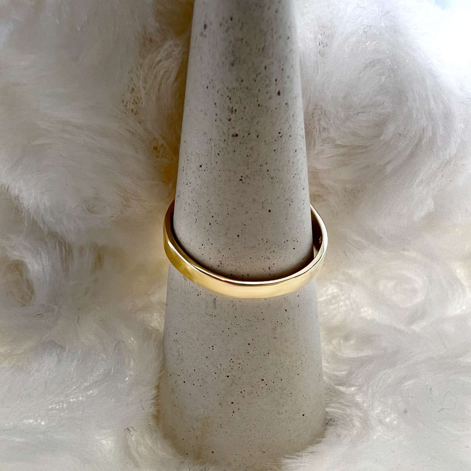 Close-up of 14kt yellow gold pink coral ring with detailed view of marquise coral stones and diamond centerpiece