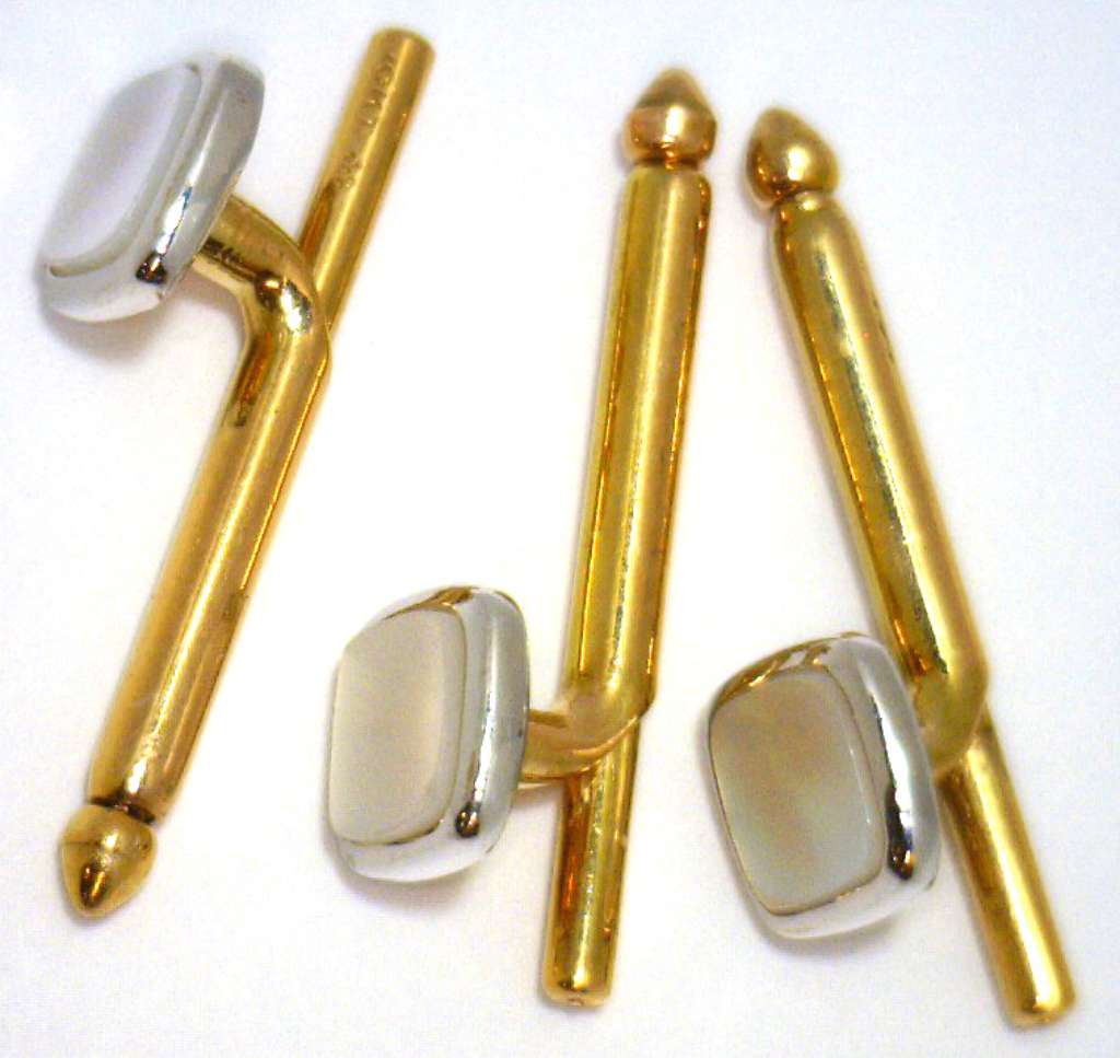 Side profile of an elegant 10kt yellow gold shirt stud with white gold bezel and white mother-of-pearl center