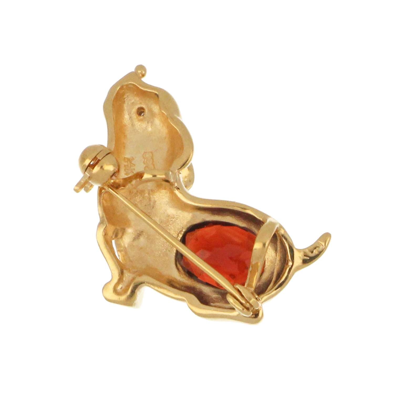 Side angle detail of 14kt yellow gold puppy style garnet brooch showing craftsmanship