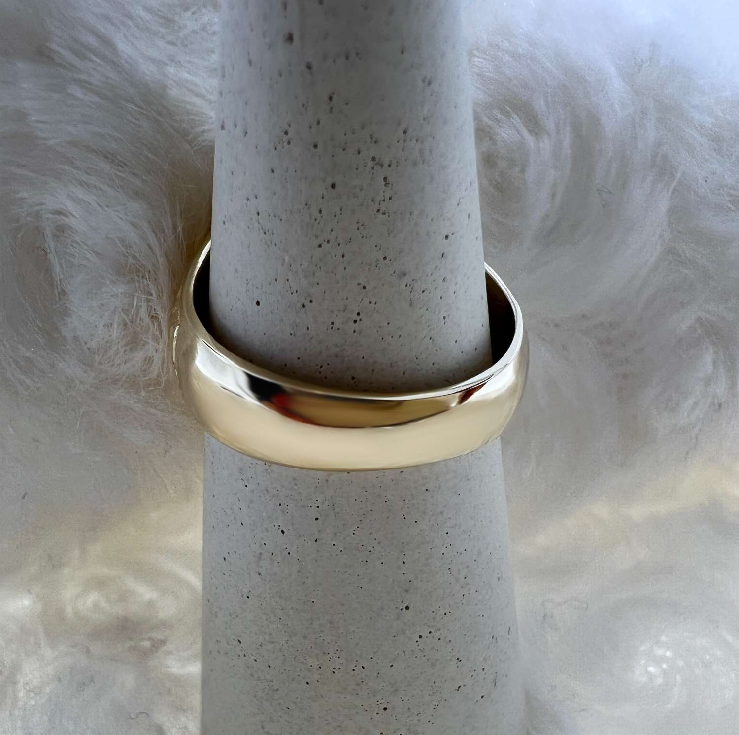 Top view of 14kt yellow gold ring featuring authentic American $1 coin in polished bezel setting