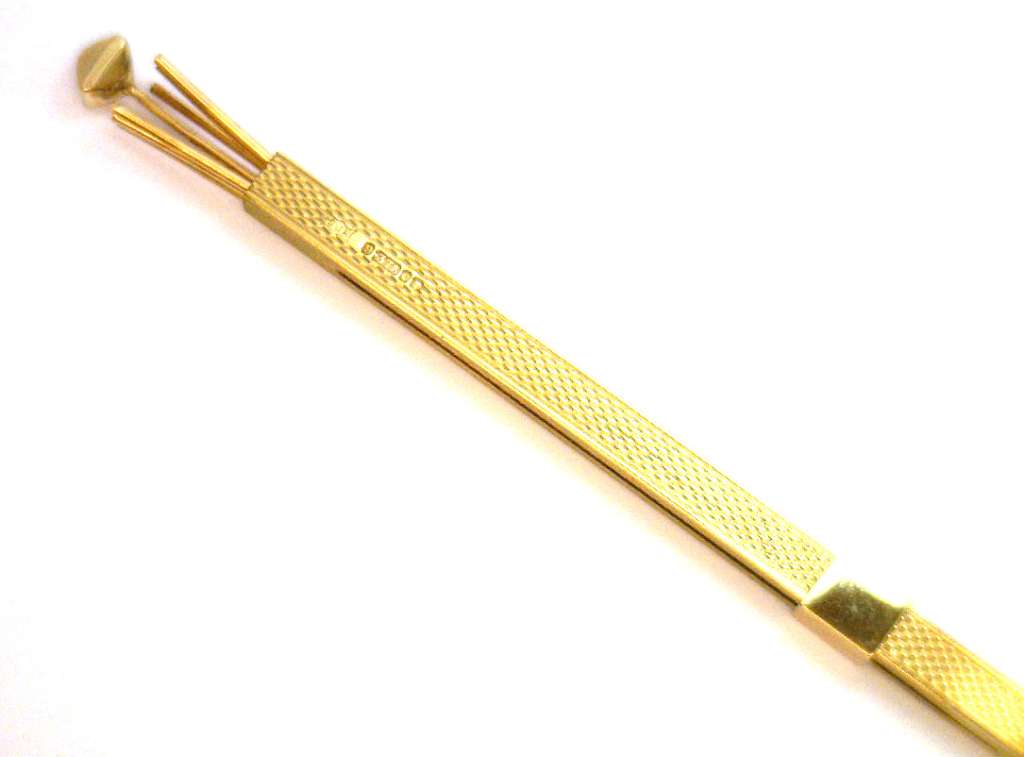 Elegant 9kt yellow gold handcrafted pendant against dark background emphasizing rich color