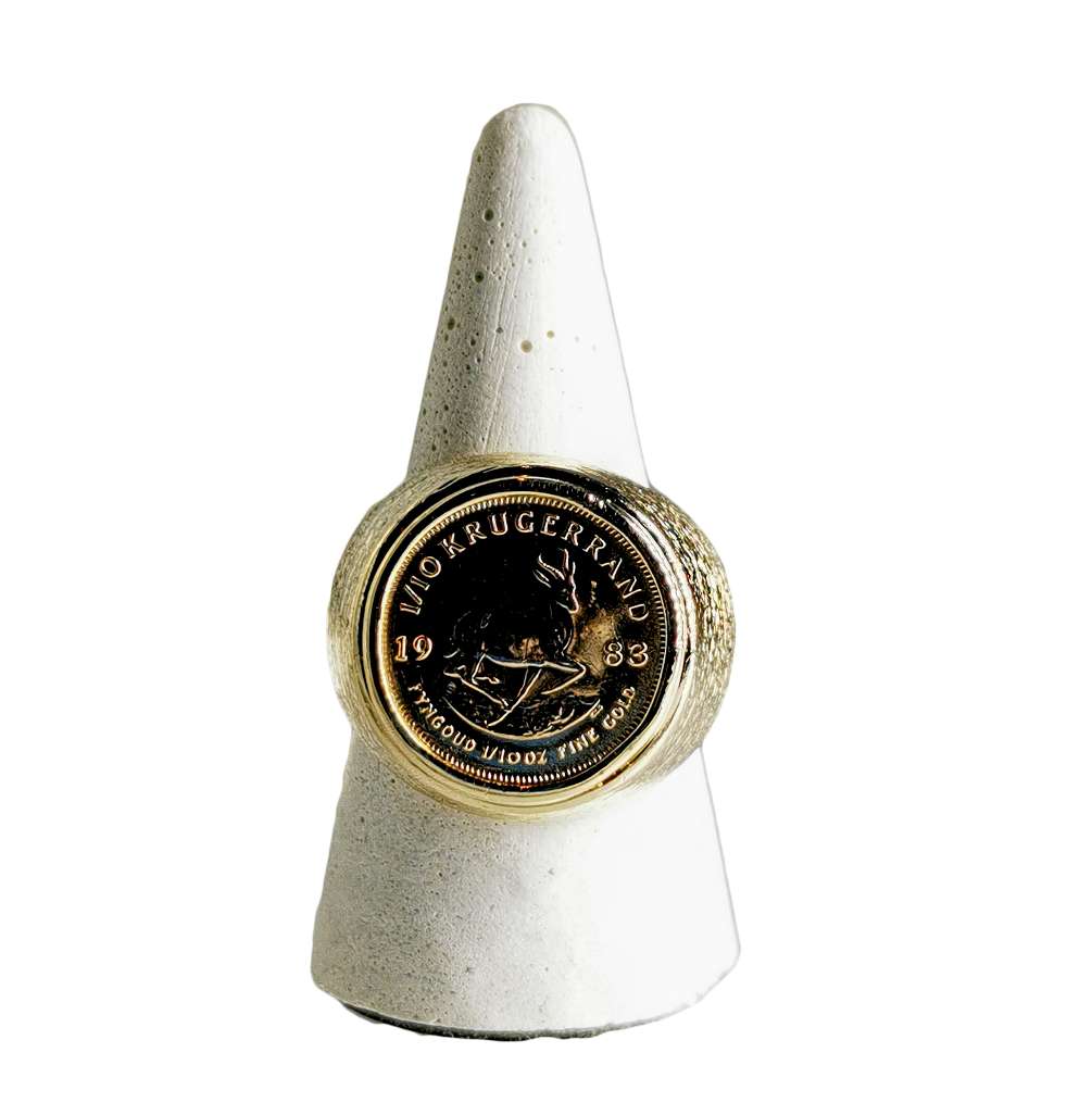 Close-up of 10kt yellow gold ring featuring 22kt yellow gold 1/10 oz Krugerrand coin inset