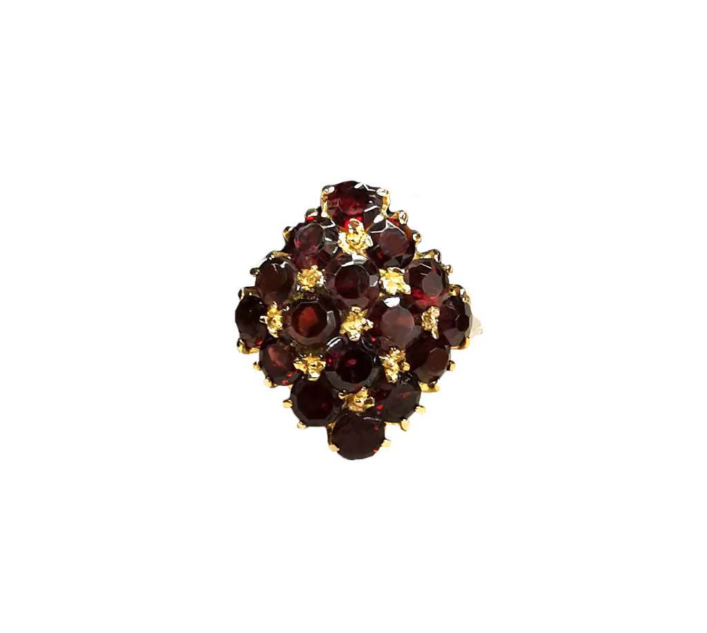 Side angle of 18kt yellow gold garnet ring highlighting the polished gold band and securely set round red garnets, displaying ring size 7