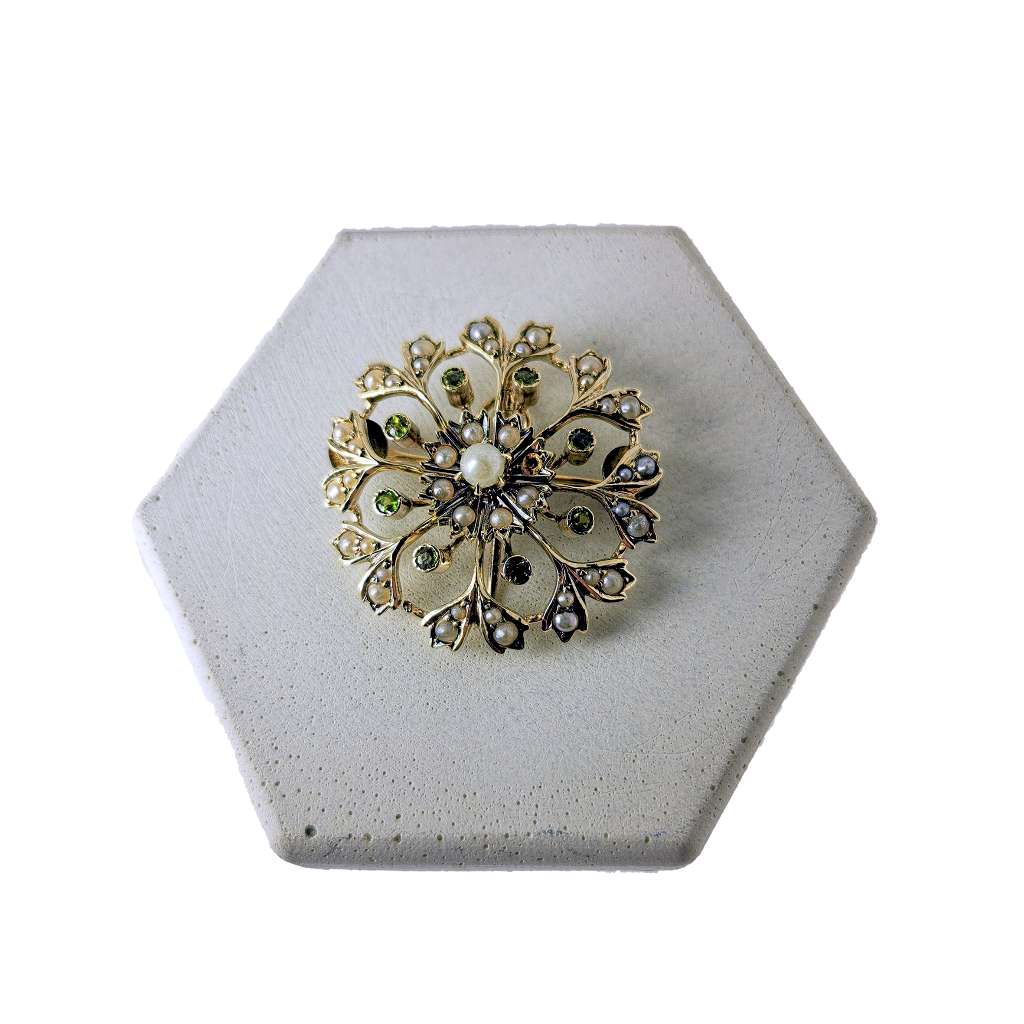 14kt yellow gold antique Victorian style pendant brooch with 40 white seed pearls and 8 round green peridots, front angle view