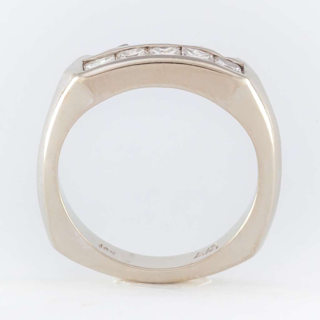 Side profile of elegant 18kt white gold wedding band with five princess cut diamonds in ring size 5.5